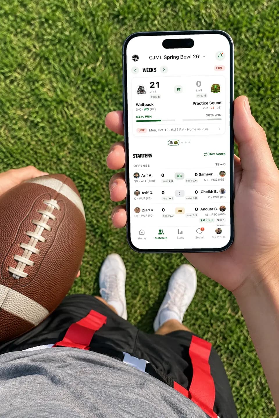 Player holding an iPhone with a live flag football score in GameGrid