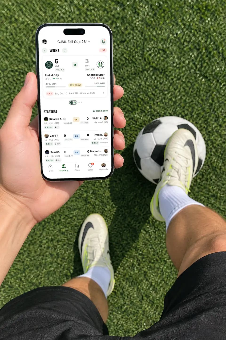 Player holding an iPhone with a live GameGrid soccer score
